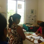Lupita's husband Carlos and Manuel of CESMACH register women for the clinic